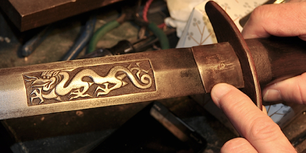 A Close-up View of Dragon Logo of A Samurai Sword.